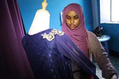 Hawa Adan Hassan, a 23 year-old university student and a young Somali female fashion designer checks her new finished fashion design, on November 3, 2018, in Mogadishu.  
 Somalia's clothes business is a simple one: foreign imported garments for the well-to-do, locally tailored clothes for the rest. But new fashion designers are complicating that picture with locally-designed, hand-made attire. / AFP / Abdi HAJJI HUSSEIN
