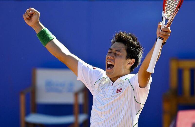 Kei Nishikori celebrates after winning the Barcelona Open final against Colombian Santiago Giraldo on Sunday. The Japanese took the match 6-2, 6-2. Josep Lago / AFP

