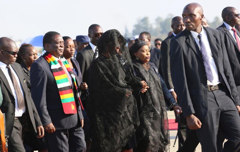 Robert Mugabe's widow Grace Mugabe, center, is escorted after a ceremony at the RG Mugabe Airport, upon the return of his remains in Harare, Zimbabwe. Known as a strong-willed woman with political ambitions, Grace Mugabe rose from being one of the president’s secretaries to become first lady. AP Photo