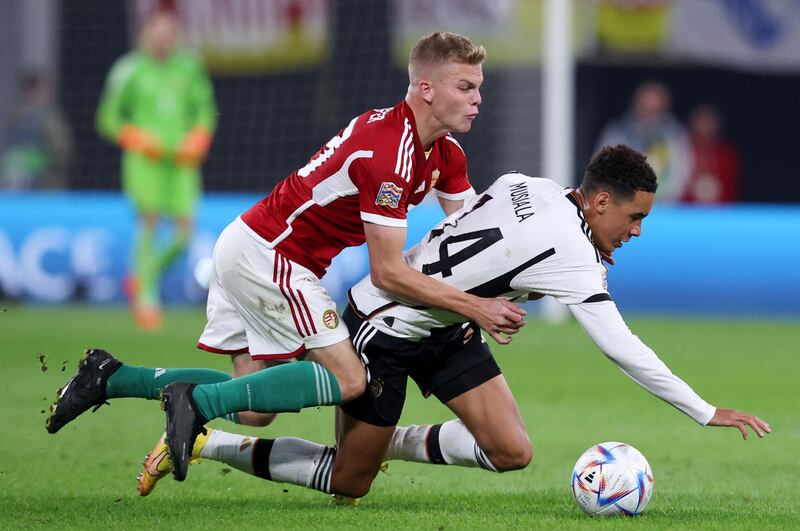 Hungary forward Andras Schaefer falls over Germany midfielder Jamal Musiala. AFP