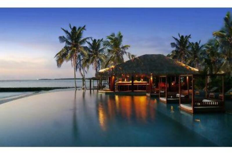 The poolside beach bar is popular at sundown. Courtesy The Residence Maldives