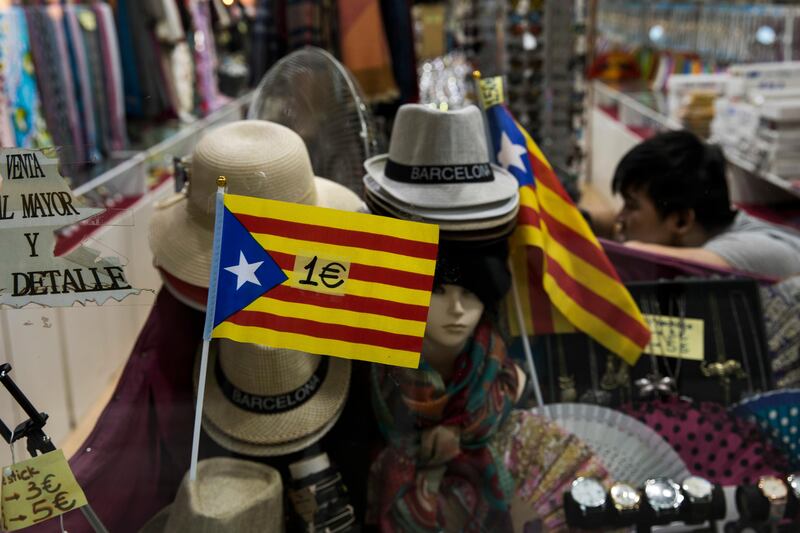 Independence flags are displayed for selling for 1 euro inside a store in downtown Barcelona, Spain, Wednesday, Oct. 25, 2017. Spain's prime minister says the government's plans to take unprecedented control of Catalonia's key affairs and halt that region's push for independence are "exceptional" and he hopes they will not last long. (AP Photo/Emilio Morenatti)