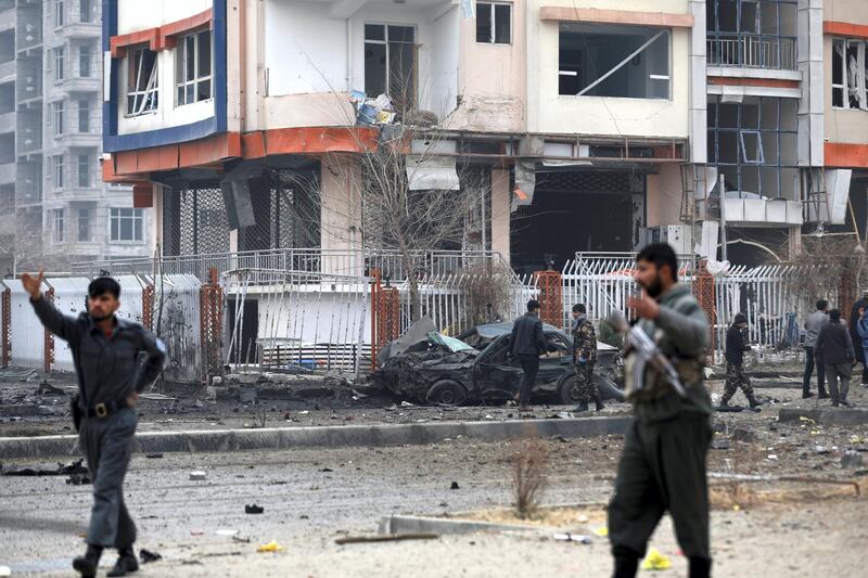 Afghan security personnel inspect the site of a bombing attack in Kabul, Afghanistan, Sunday, Dec. 20, 2020. The strong car bomb explosion rocked the capital Kabul city on Sunday morning, killing multiple people, said a government official. (AP Photo/Rahmat Gul)