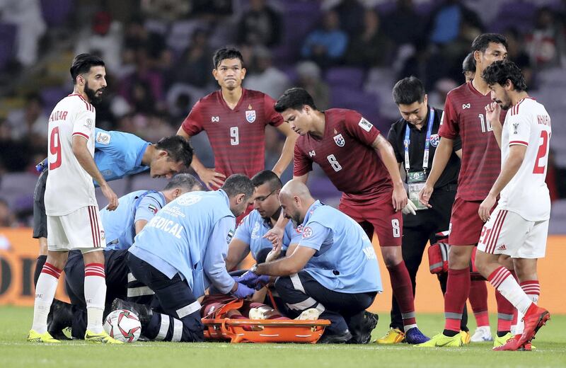 Al Ain, United Arab Emirates - January 14, 2019: Mika Chunuonsee of Thailand is stretchered off during the game between UAE and Thailand in the Asian Cup 2019. Monday, January 14th, 2019 at Hazza Bin Zayed Stadium, Al Ain. Chris Whiteoak/The National