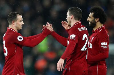 LIVERPOOL, ENGLAND - DECEMBER 16:  Xherdan Shaqiri of Liverpool celebrates with team mates Andy Robertson and Mohamed Salah of Liverpool following their side's victory in the Premier League match between Liverpool FC and Manchester United at Anfield on December 16, 2018 in Liverpool, United Kingdom.  (Photo by Clive Brunskill/Getty Images)