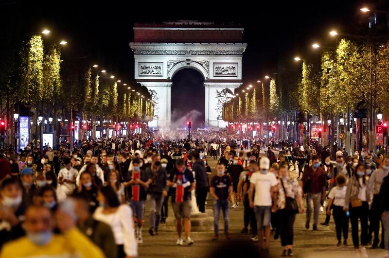 Paris Saint-Germain supporters leave the Champs-Elysees. EPA