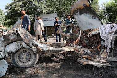 Afghans security personnel investigate at the site of a bomb explosion in front of Kanul University in Kabul on July 19, 2019. AFP