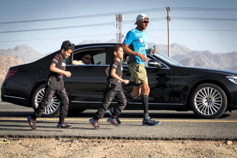 Dr Al Suwaidi is accompanied by children for part of his 1,850km run to Makkah from Abu Dhabi.