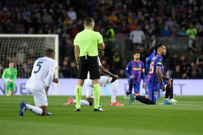Players take a knee in support of anti-racism campaigns at the start of the Europa League football match between Barcelona and Napoli in Barcelona in 2022. AFP