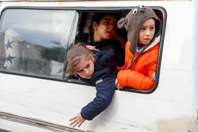 Students look out from a window of a bus in Beirut, Lebanon December 12, 2019. Reuters