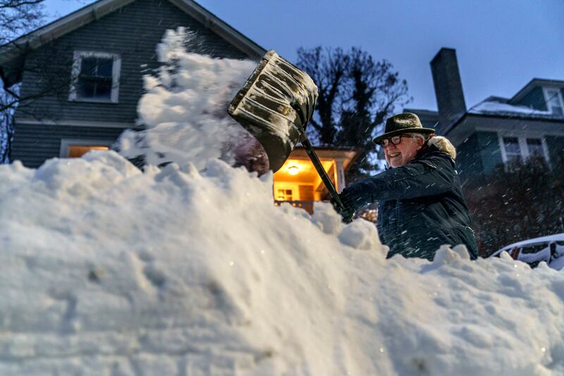 Resident Mike Ratcliffe shovels snow from his driveway in Providence. AP
