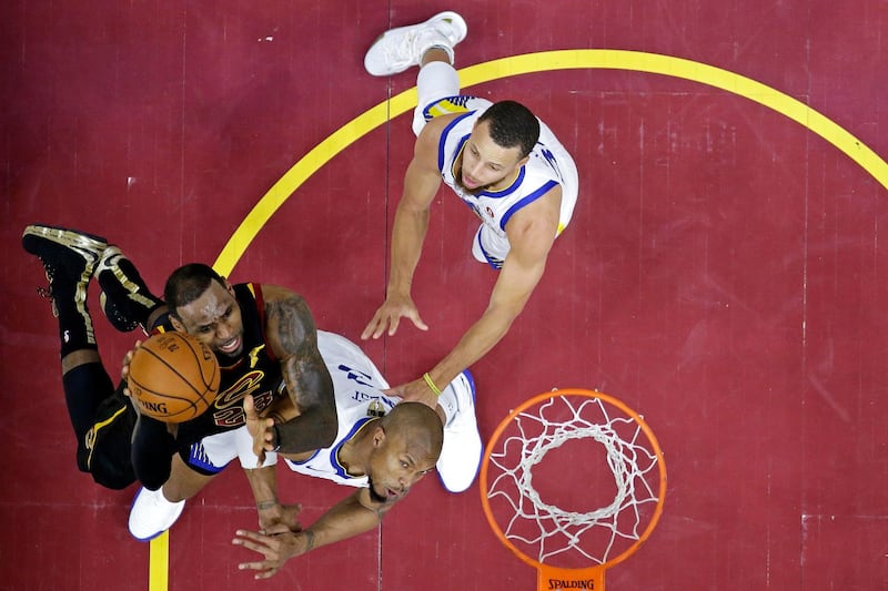 Cleveland Cavaliers forward LeBron James shoots the ball against Golden State Warriors forward David West. Carlos Osorio / Reuters