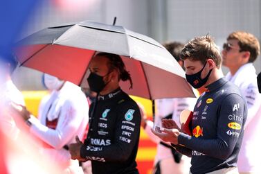 FILE PHOTO: Formula One F1 - British Grand Prix - Silverstone Circuit, Silverstone, Britain - July 18, 2021 Mercedes' Lewis Hamilton and Red Bull's Max Verstappen before the race Pool via REUTERS / Lars Baron / File Photo