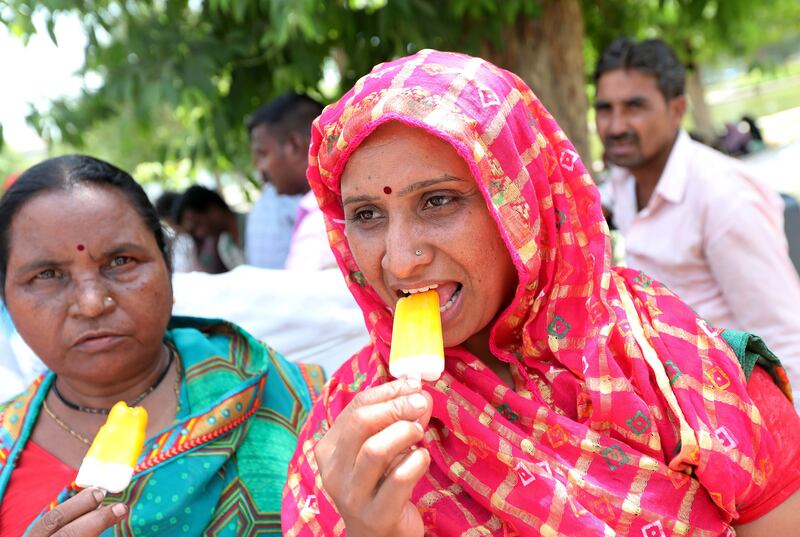 Indian women eat ice lollies in New Delhi. The India Meteorological Department has issued a heat red alert for Delhi, Rajasthan, Haryana, Punjab and Madhya Pradesh. EPA