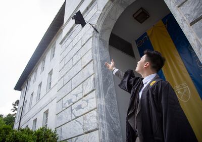 A student throws his graduation cap in the air in practice for the graduation ceremony at Emory University. AP