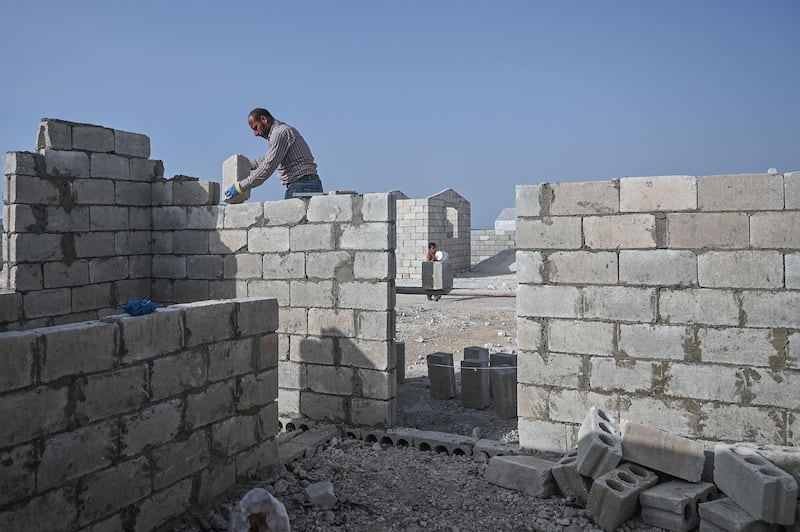 A construction worker at the site for new homes for displaced Syrians at Kafr Lusin. AFP