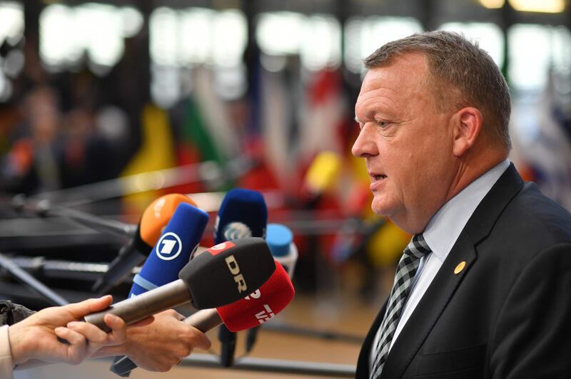 Denmark's Prime Minister Lars Lokke Rasmussen speaks to journalists as he arrives to take part in an European Union leaders' summit focused on migration, Brexit and eurozone reforms on June 28, 2018 at the EU headquarters in Brussels. The two-day meeting in Brussels is expected to be dominated by deep divisions over migration, with German Chancellor saying the issue could decide the fate of the bloc itself. / AFP / Ben STANSALL
