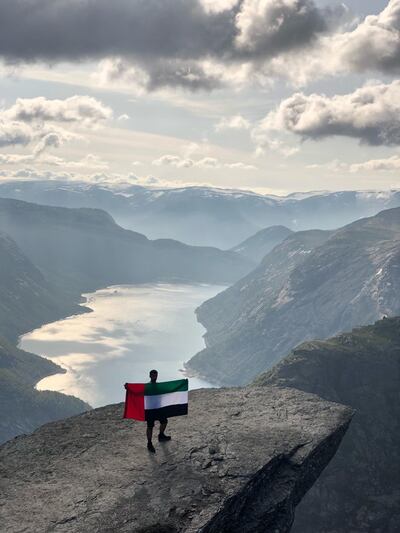 Three Emirati trekkers are spreading the word about the UAE, by flying the flag at the summit of Trolltunga, in Norway.    