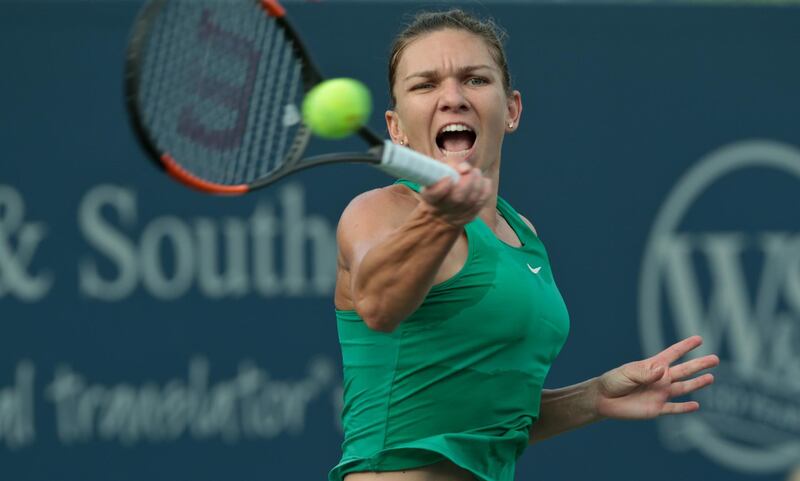 epa06955225 Simona Halep of Romania in action against Lesia Tsurenko of Ukraine during the Western and Southern Open at the Lindner Family Tennis Center in Mason Ohio, USA on August 17, 2018.  EPA/Mark Lyons