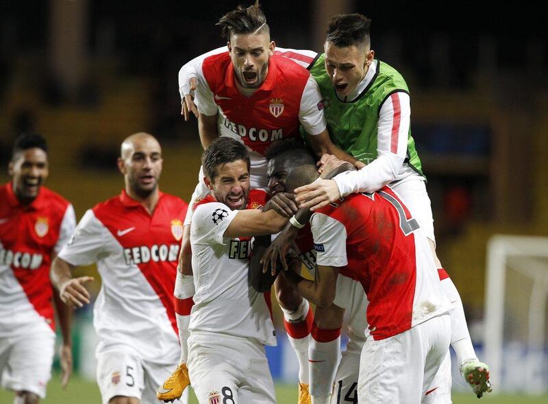 Fabinho of AS Monaco is mobbed by teammates after scoring against Zenit St Petersburg in their 2-0 Champions League victory to advance to the last 16 on Tuesday night. Sebastien Nogier / EPA / December 9, 2014 