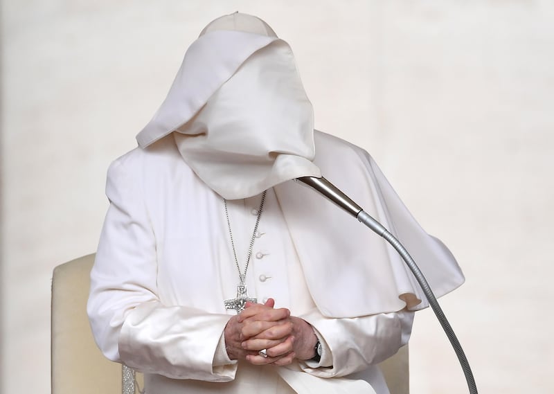 Pope Francis's cape covers his face as he leads the weekly general audience on Saint Peter's Square in the Vatican City. EPA