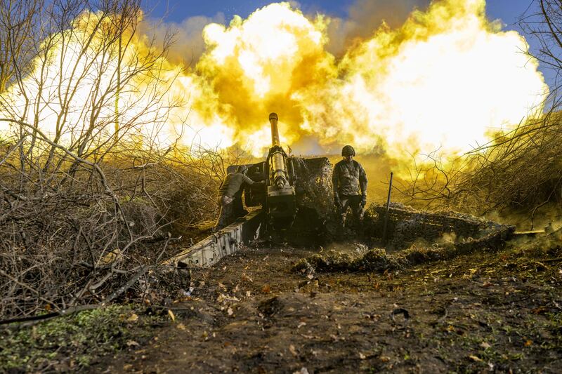 A Ukrainian artillery unit soldier fires at Russian positions outside Bakhmut on November 8. AFP