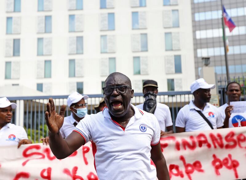 A protester shouts about the rising costs of phone services. Reuters