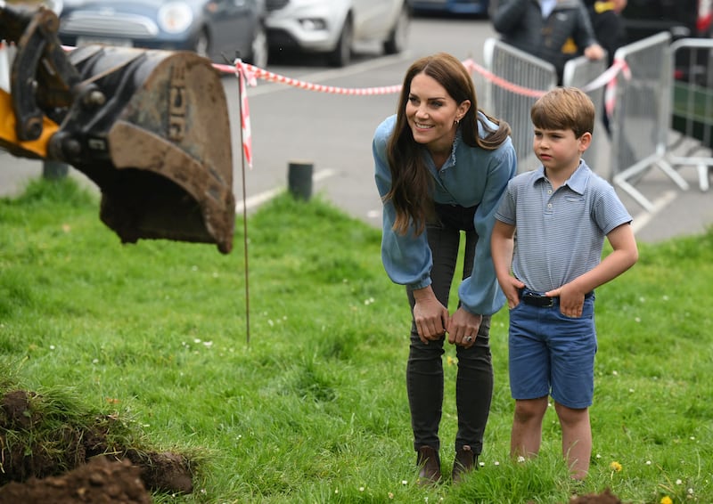 The Princess of Wales and Prince Louis watch Prince William (not pictured) use a digger. Reuters