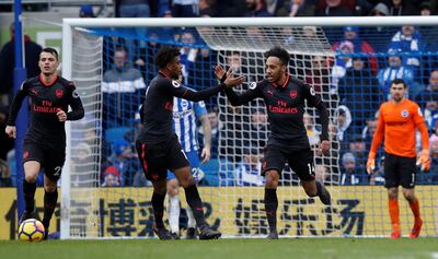 Soccer Football - Premier League - Brighton & Hove Albion vs Arsenal - The American Express Community Stadium, Brighton, Britain - March 4, 2018   Arsenal's Pierre-Emerick Aubameyang celebrates scoring their first goal with Alex Iwobi    REUTERS/Eddie Keogh    EDITORIAL USE ONLY. No use with unauthorized audio, video, data, fixture lists, club/league logos or "live" services. Online in-match use limited to 75 images, no video emulation. No use in betting, games or single club/league/player publications.  Please contact your account representative for further details.