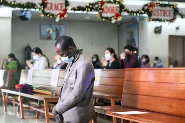 Devotees during Christmas mass at St Joseph's Church in Abu Dhabi. Khushnum Bhandari / The National