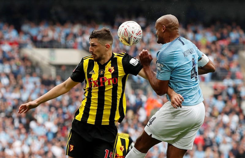 Manchester City's Vincent Kompany in action with Watford's Craig Cathcart. Reuters