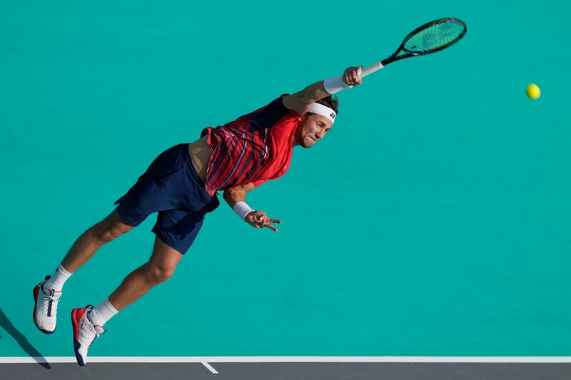 Casper Ruud serves to Carlos Alcaraz. AP