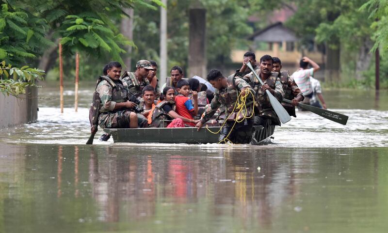 The army pulls affected villagers to safety.