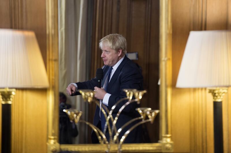 LONDON, ENGLAND - AUGUST 30: British Prime Minister Boris Johnson is reflected in a mirror as he arrives to take questions from young people aged between 9-14 to coincide with an education announcement at 10 Downing Street on August 30, 2019 in London, England. (Photo by Jeremy Selwyn - WPA Pool/Getty Images)