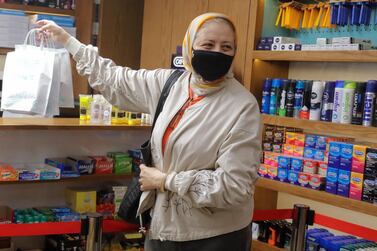 An Egyptian woman wears a protective mask in a Cairo pharmacy during the Covid-19 pandemic. Reuters