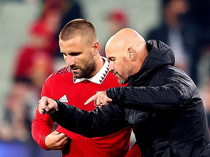 Manchester United coach Erik ten Hag speaks with Luke Shaw during their pre-season tour of Australia in July. AFP