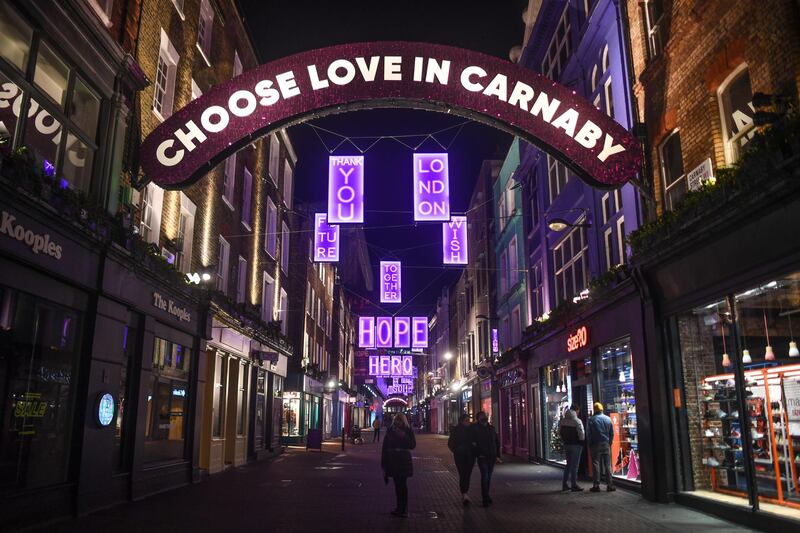 Festive lights hang over an otherwise quiet Carnaby Street in London, England. London and large parts of southern England were moved into a newly created Tier 4 lockdown, closing non-essential shops and limiting household mixing. Getty Images