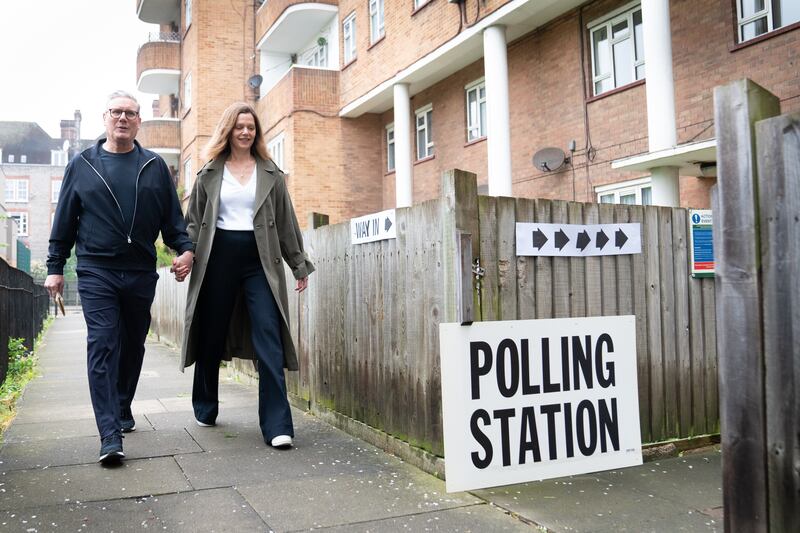 Labour leader Keir Starmer and his wife Victoria arrive at their local polling station in north London. PA