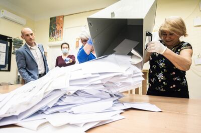 Members of the voting committee collect ballots at a polling station in Budapest. Bloomberg