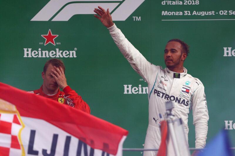 MONZA, ITALY - SEPTEMBER 02:  Lewis Hamilton of Great Britain and Mercedes GP celebrates his victory on the podium next to Kimi Raikkonen of Finland and Ferrari during the Formula One Grand Prix of Italy at Autodromo di Monza on September 2, 2018 in Monza, Italy.  (Photo by Dan Istitene/Getty Images)