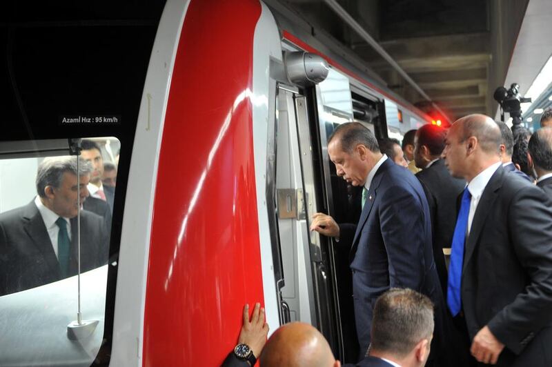 Turkish Prime Minister Recep Tayyip Erdogan (2nd from right) enters the train's cabin after President Abdullah Gul (left) at the Uskudar Marmaray station. Ozan Kose / AFP



