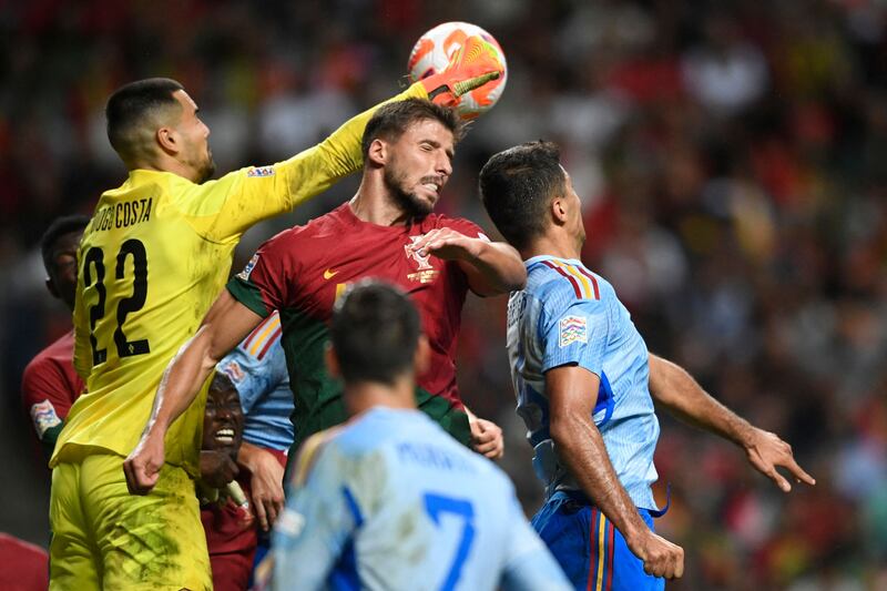 Portugal defender Ruben Dias challenges for a header during the game against Spain. AFP