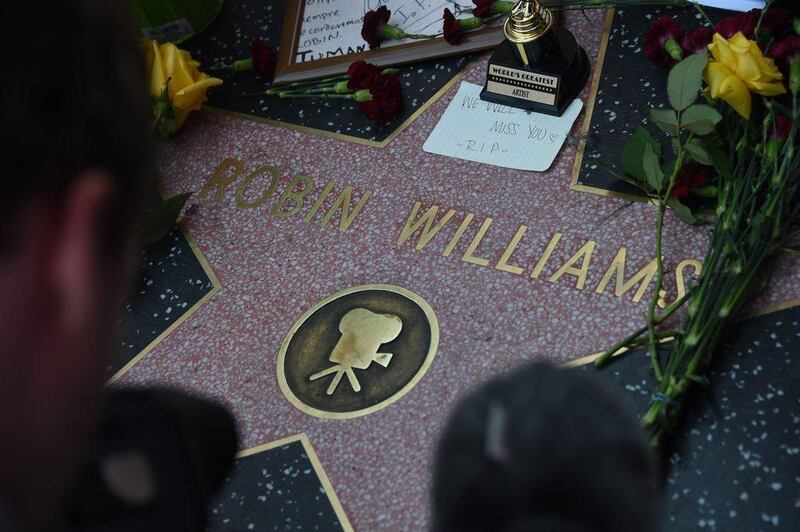 Flowers and momentos left by fans are seen at Robin Williams' star on the Hollywood Walk of Fame is seen, August 11, 2014, in Hollywood, California. AFP  