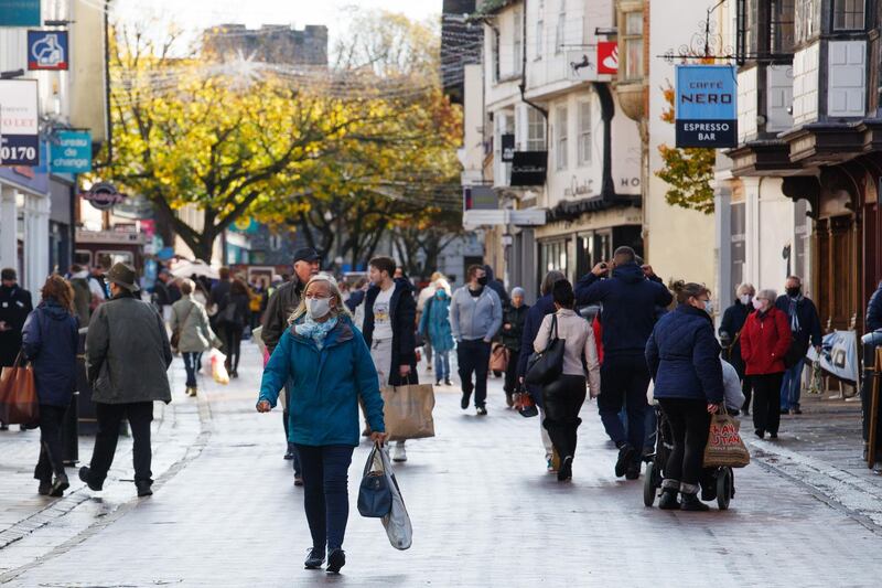 People shop in Canterbury, U.K., on Tuesday, Nov. 3, 2020. U.K. retailers face a Christmas disaster after the government ordered non-essential stores across England to shut for four weeks just as the busiest shopping season of the year was getting under way. Photographer: Luke MacGregor/Bloomberg