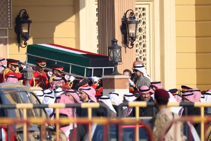 The coffin of Kuwait's late Emir Sheikh Nawaf al-Ahmad Al-Sabah is carried out of the Bilal bin Rabah Mosque in Kuwait City ahead of burial during his funeral on December 17, 2023.  Kuwait saw a quick transition to a new emir on December 16 following the death at 86 of Sheikh Nawaf al-Ahmad Al-Sabah after three years in power.  (Photo by Yasser Al-Zayyat  /  AFP)