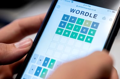 An illustration photo shows a person playing online word game "Wordle" on a mobile phone in Washington, DC. AFP