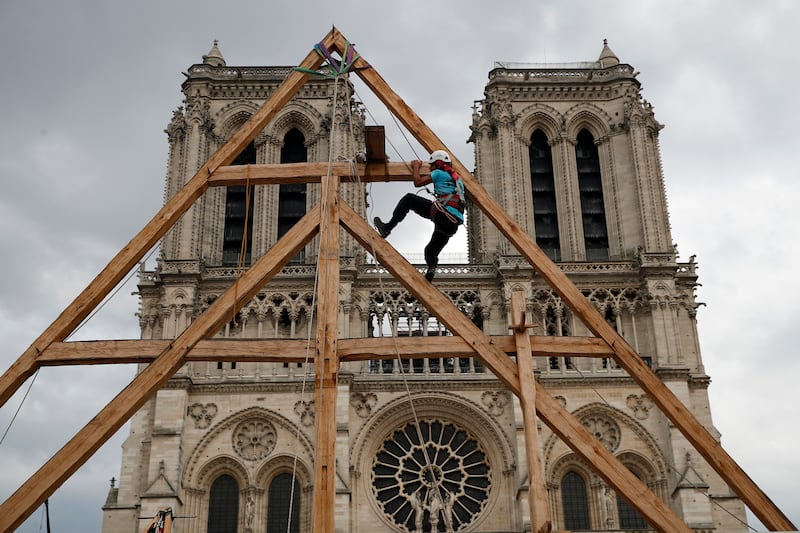 Charles, one of the carpenters restoring Notre Dame Cathedral, puts his medieval building skills on show in September 2020. AP