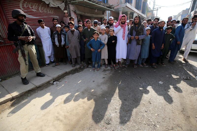 People gather at the scene of an explosion at an Islamic seminary in Peshawar, Pakistan.  EPA