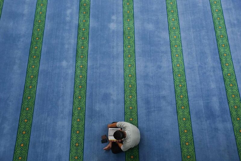 A Malaysian Muslim reads the Quran during a lunch break on the 2nd day of the holy month of Ramadan inside a mosque in Kuala Lumpur on June 30, 2014. Samsul Said/Reuters