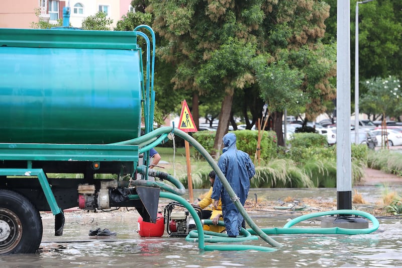 Tankers help to clear water from the streets in Discovery Gardens, Dubai. Pawan Singh / The National